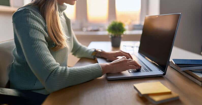 Young woman using laptop at desk